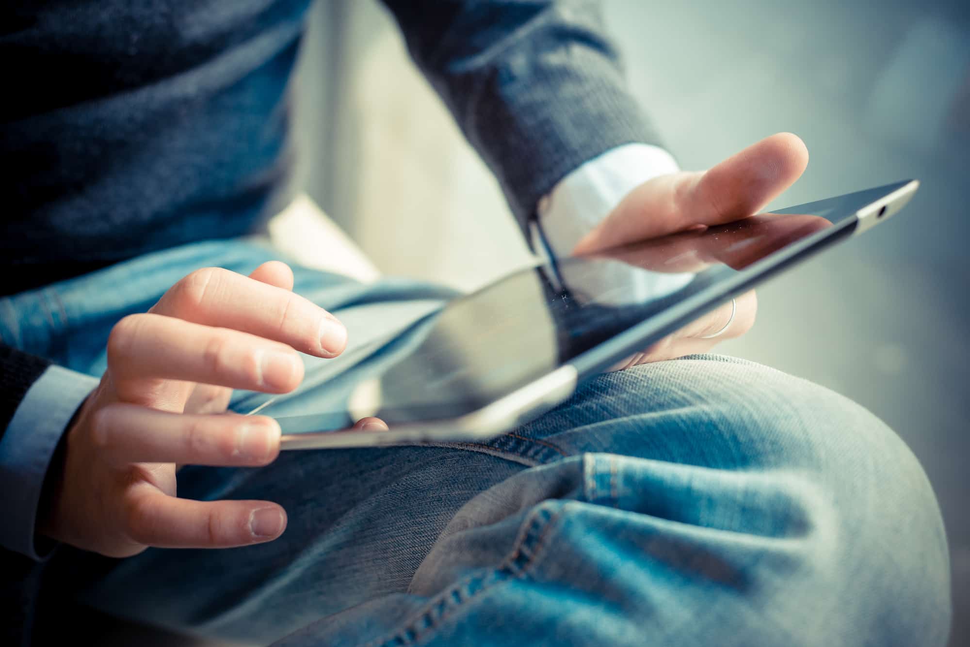 using a tablet to write an employee handbook